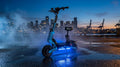 VelociTech 5600W Beast electric scooter on industrial waterfront at twilight